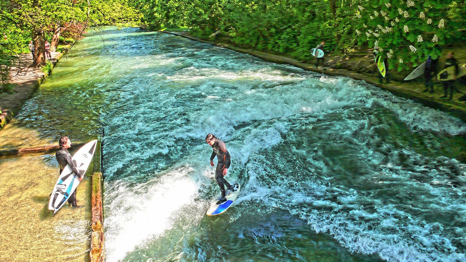 A surfer on the standing wave of the Eisbach in Munich